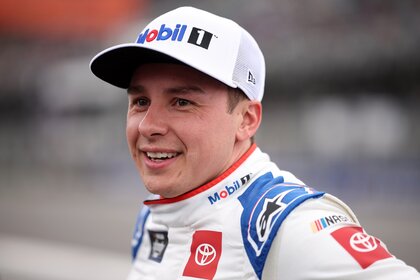 Christopher Bell smiles in his NASCAR suit.