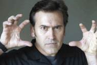 Bruce Campbell poses doing scary claw hands.